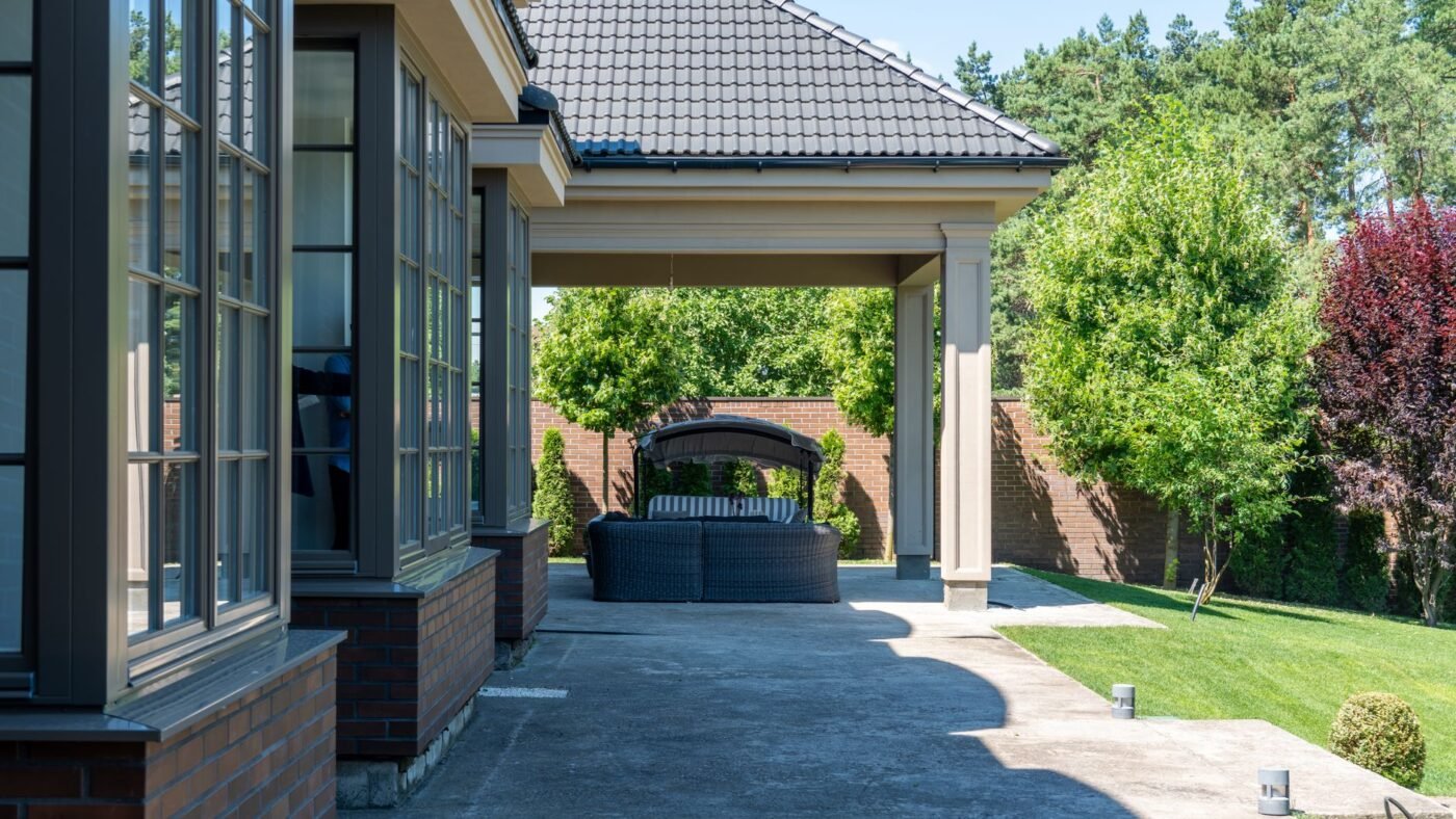 Poured concrete patio and walkway beside a house, the kind of slab that benefits from concrete patio sealing
