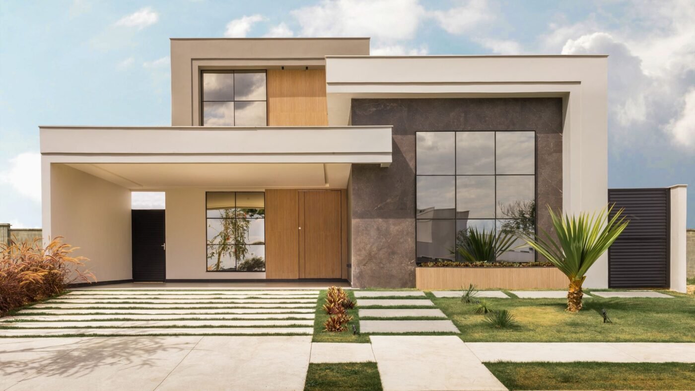 Contemporary house with long rectangular modern pavers set as stepping pads in a lawn, leading to the front door