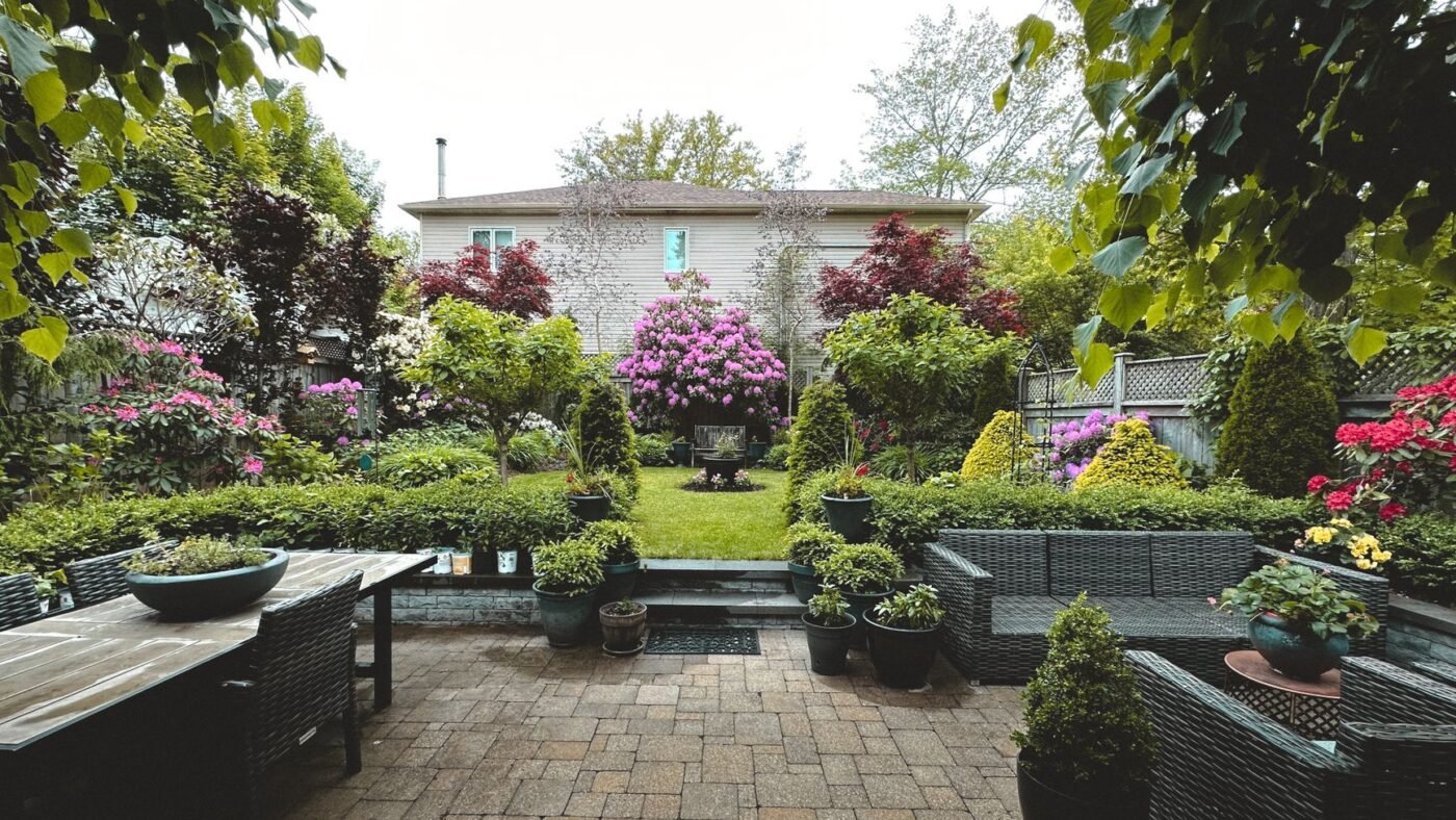Backyard concrete paver patio with an outdoor dining table and sofa set, the kind of project a patio pavers price estimate covers
