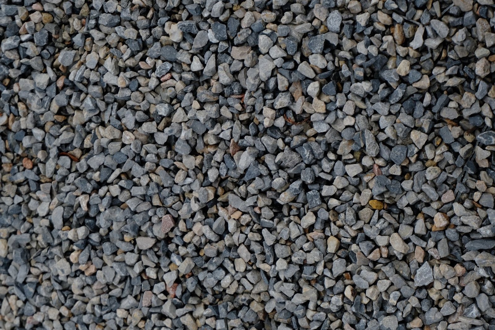Clean angular open-graded stone with no fines, used as a permeable paver base