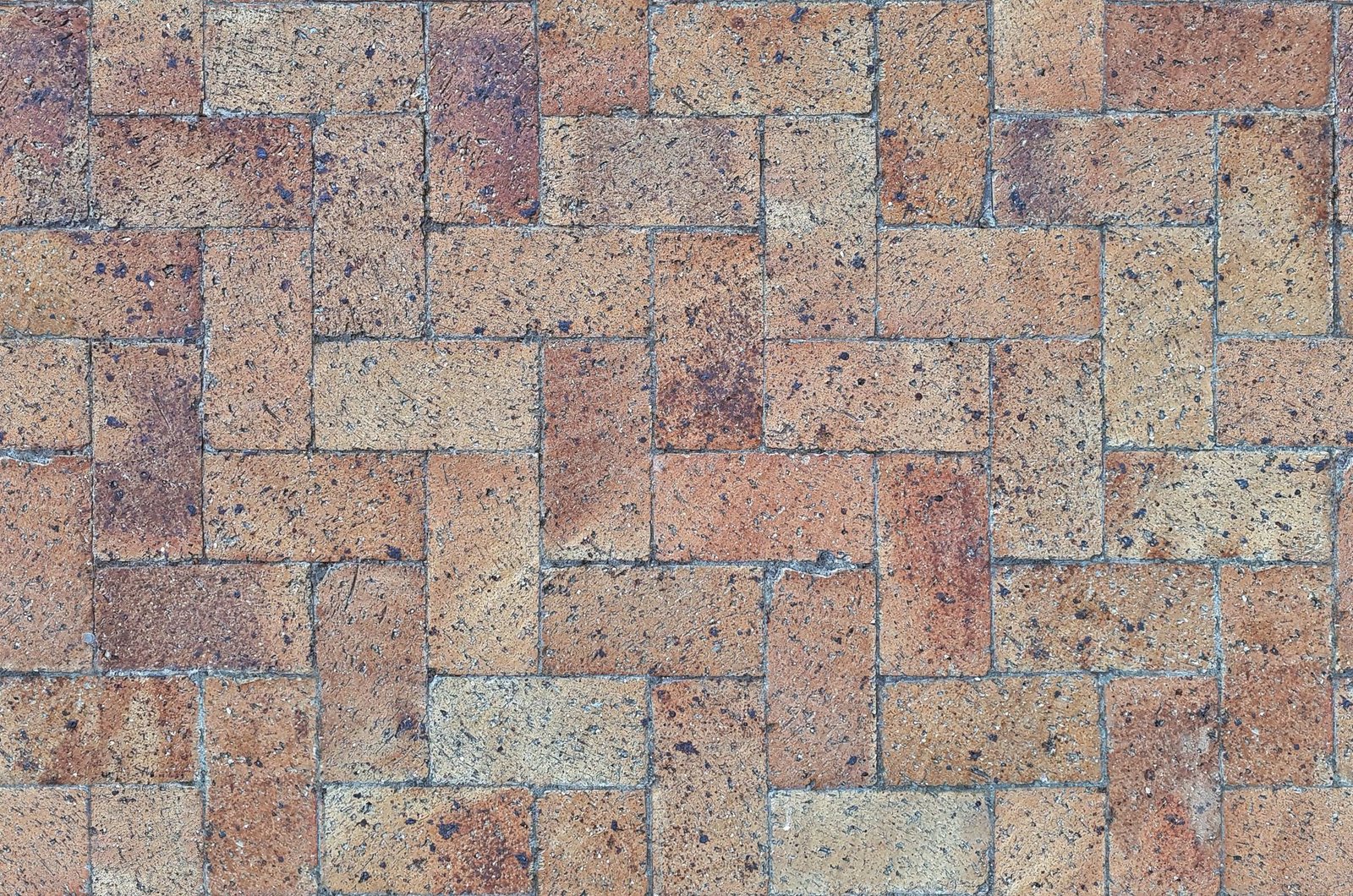 Brick pavers laid in a herringbone pattern, one of the strongest paver installation patterns