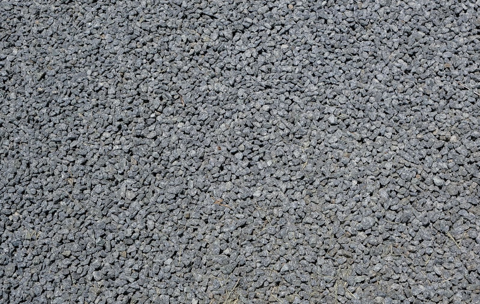 Close-up of small clean angular crushed stone with no fines, like the chip stone used in permeable paver joints and bedding