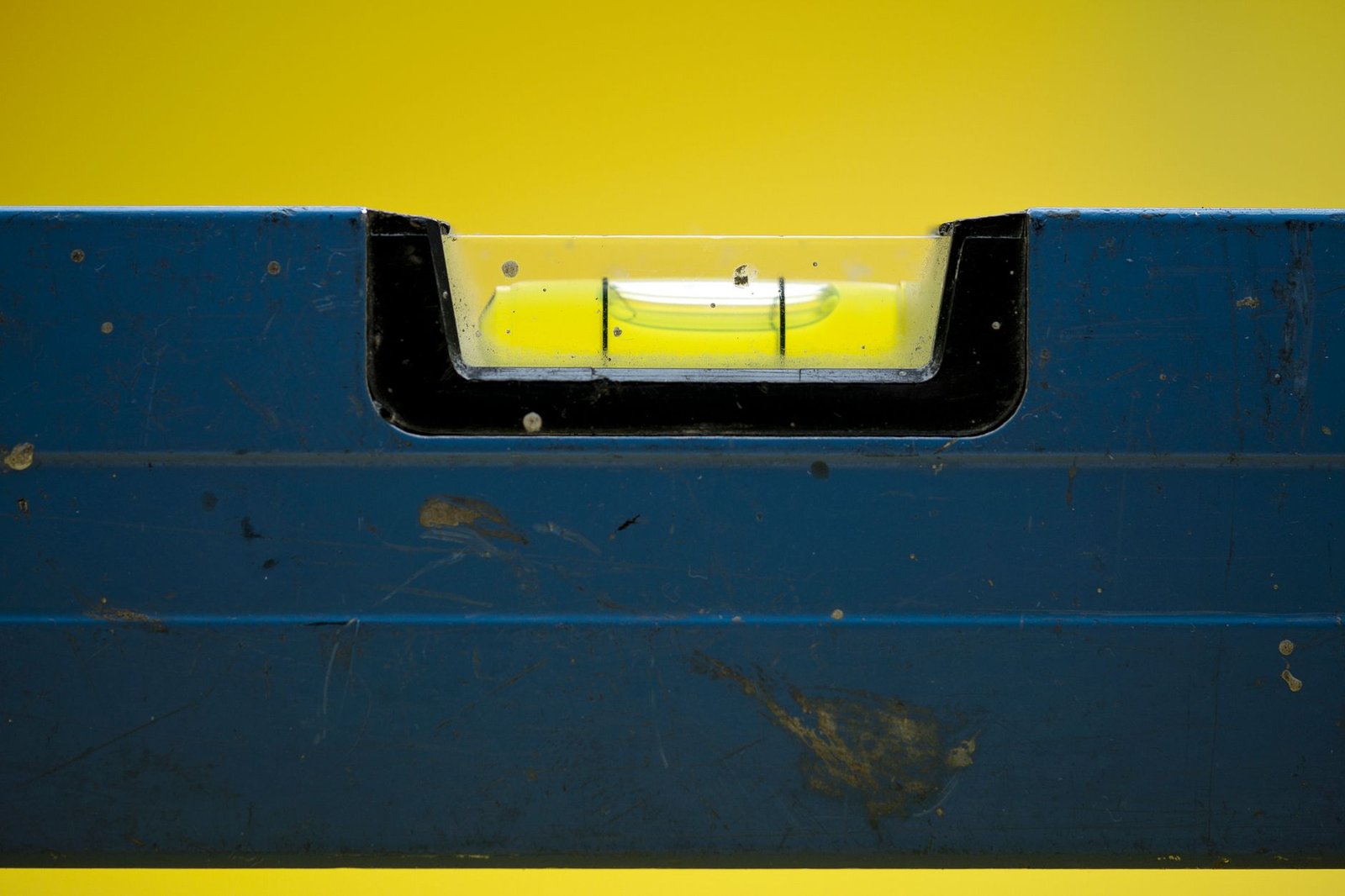 Close-up of a spirit level bubble vial used to check screed rails and slope when screeding sand for pavers