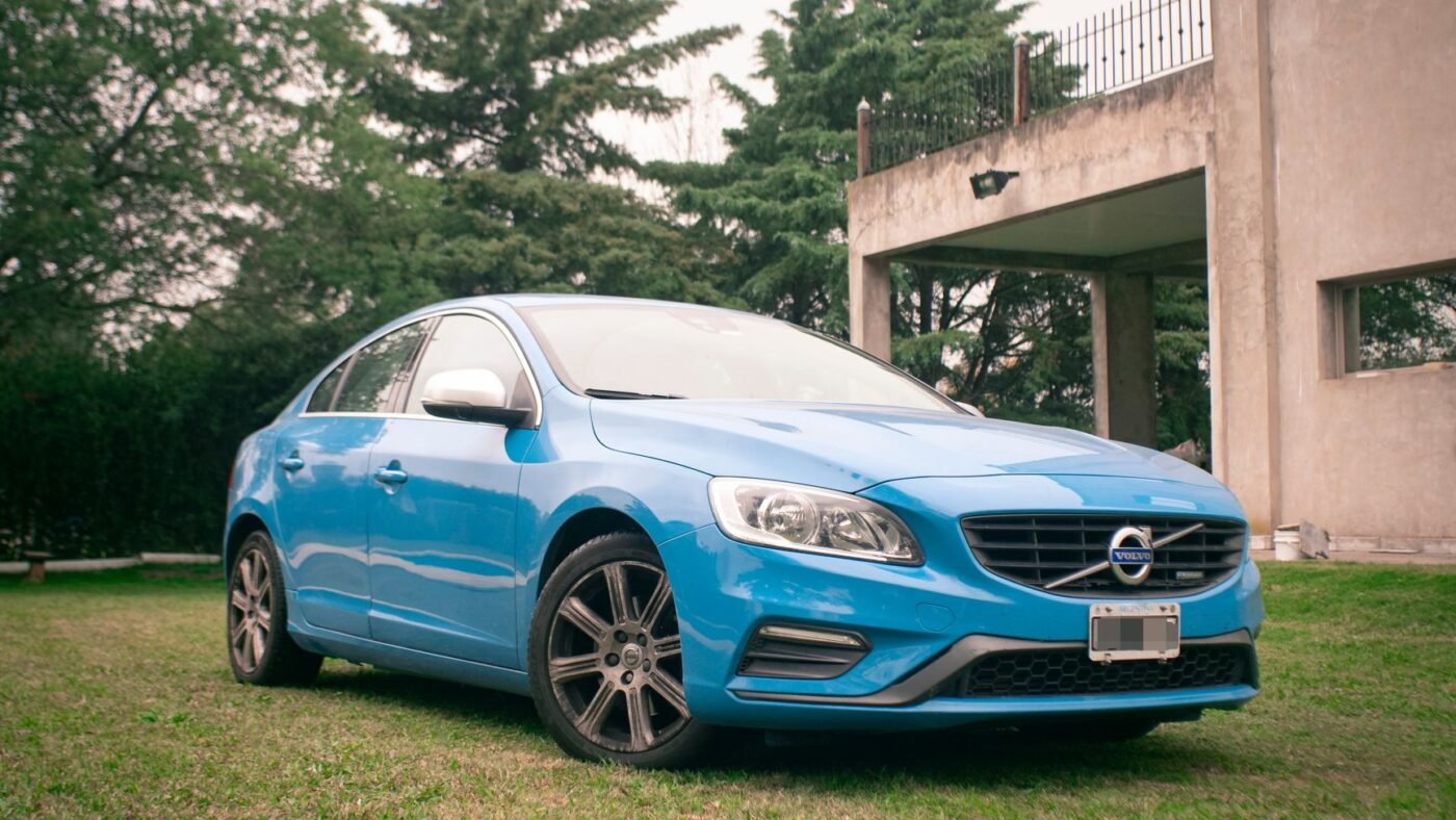 Car parked on a plain grass lawn, the kind of overflow parking turfstone pavers are made to reinforce
